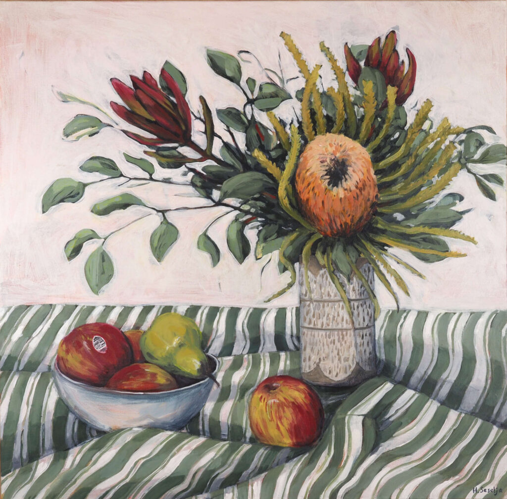An expressive still life painting of Australian native flowers in a ceramic vase beside a bowl of apples and pears on a green and white striped cloth. Rich reds, greens and warm neutrals create a balanced composition, while the flowing pattern of the fabric adds movement and rhythm to the scene.